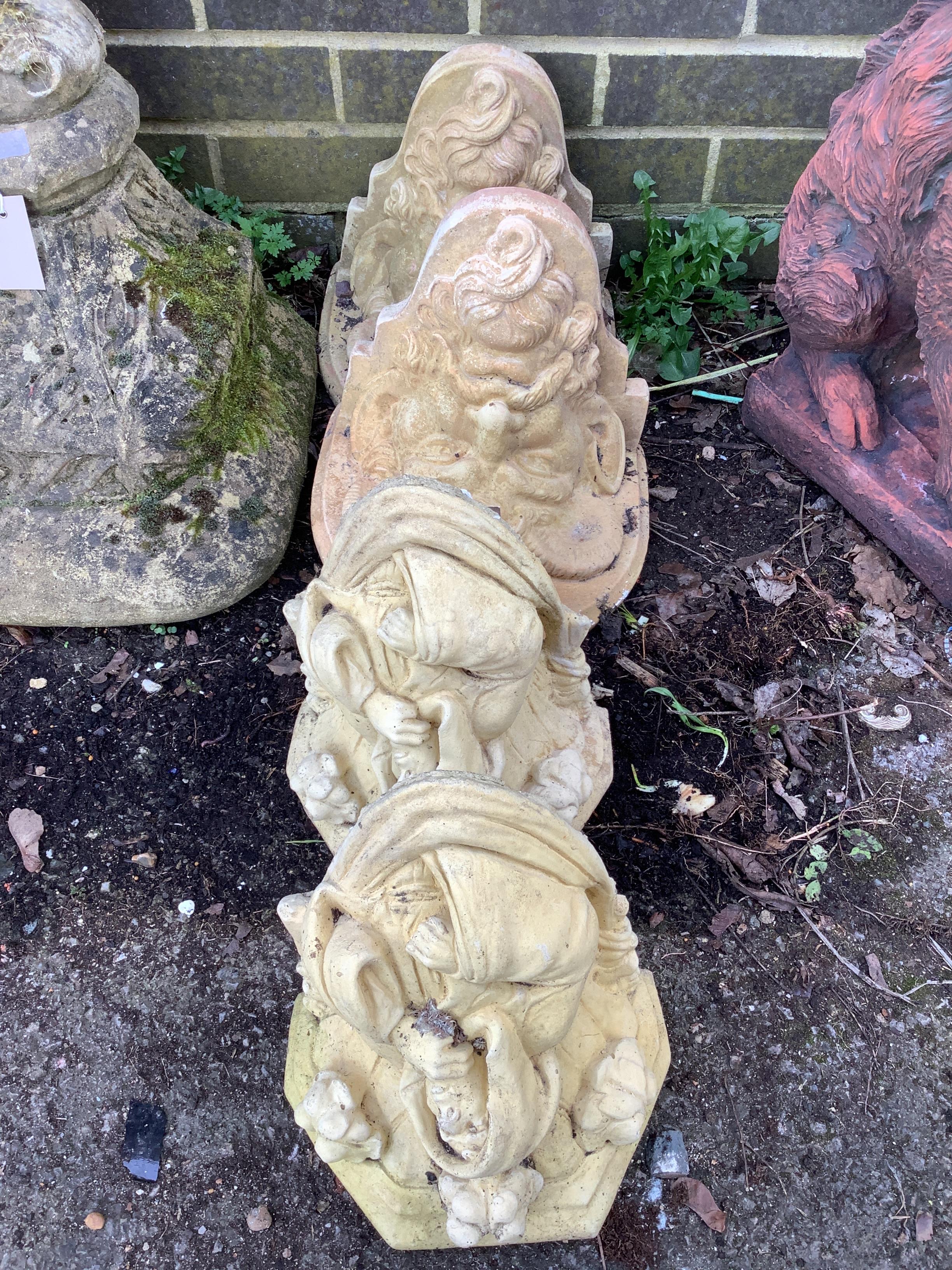 Two pairs of cast stone garden wall brackets, largest height 20cm